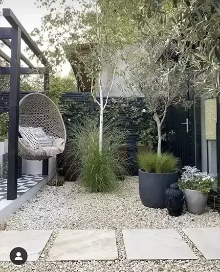 Luxury garden with seating, planting, silver birch trees and patio area designed and build by Roots Landscapes and Trees