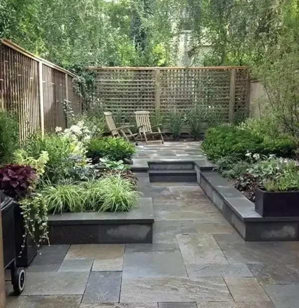 Garden with seating and patio area designed and build by Roots Landscapes and Trees
